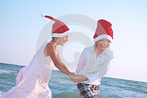 Santa children on the beach