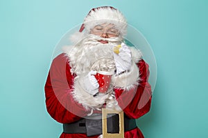 Santa Claus adding lemon into tea cup