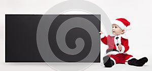 Santa Claus baby hold black advertisment banner blank photo
