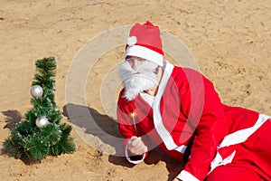 Santa Claus on the beach with a Christmas tree