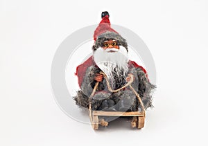 Santa Claus with a beard on a sled tree toy isolated