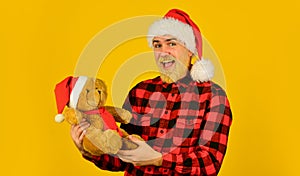 Santa Claus. Bearded man celebrate christmas. Christmas memories from childhood. Kind hipster with teddy bear. Charity