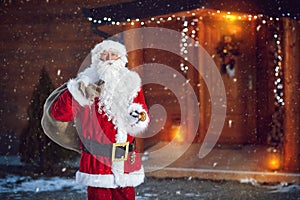 Santa Claus with bell and sack of presents