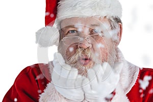 Santa claus blowing fake snow