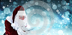 Santa Claus blowing magic snow around, bokeh effect. Space for text