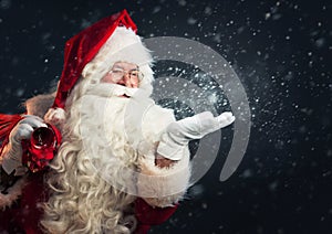 Santa Claus blowing snow of his hands