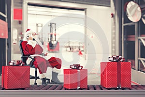 Santa Claus busy with the orders of Christmas gifts in a warehouse