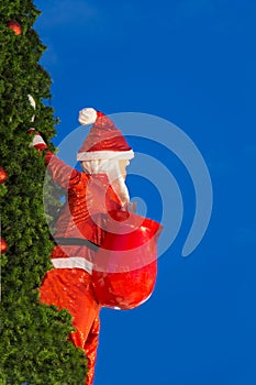 Santa Claus carrying a bag on the Christmas tree