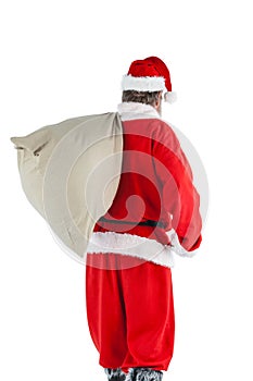 Santa claus carrying bag full of gifts