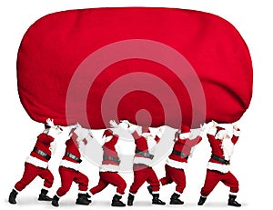 Santa claus carrying big and heavy gift red sack