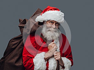 Santa Claus carrying Christmas gifts