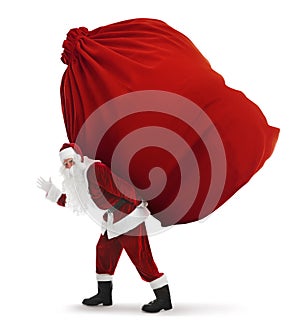 Santa Claus carrying enormous red bag full of Christmas gifts on white background