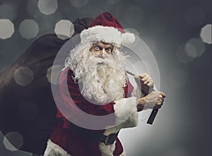 Santa Claus carrying a sack with Christmas gifts