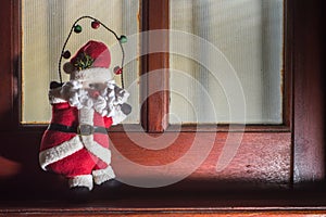 Santa Claus, Christmas concept with Santa Claus climbing a rope, Copy space to the left and window in the background