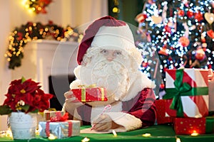 Santa Claus on Christmas eve. Presents under tree