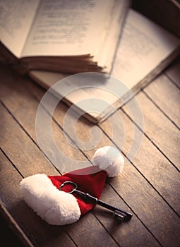 Santa Claus Christmas hat with classic key and old books