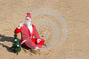 Santa Claus with a Christmas tree on the beach