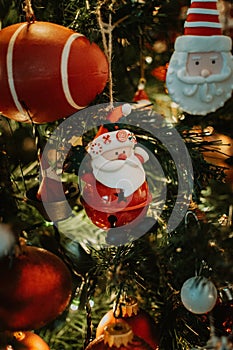 Santa Claus Christmas tree decoration ornament on a branch with lights on
