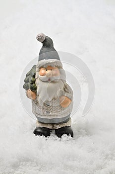 Santa Claus with Christmas tree on Snow Background, vertical