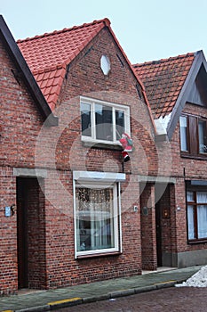 Santa Claus climbs into the house before Christmas to put gifts in Belgium