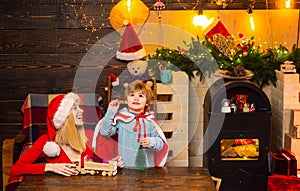Santa claus coming. Family holiday. Mother and little child boy adorable friendly family having fun. Family having fun