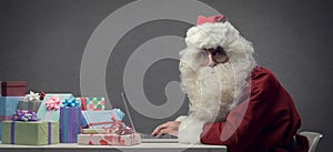 Santa Claus connecting with his laptop