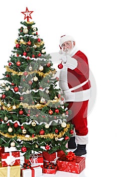 Santa Claus decorating Christmas tree