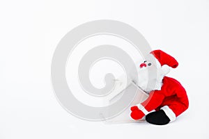 Santa claus doll holding a small wooden house on isolated on white background,Christmas decoration