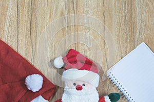 Santa Claus doll with Santa Claus red hat and notebook