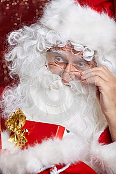 Santa Claus drinking tea Closeup Portrait Isolated on red