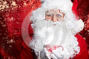 Santa Claus drinking tea Closeup Portrait Isolated on red