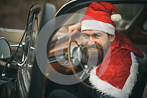 Santa Claus driver smiling at wheel