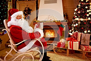 Santa Claus enjoying and reading children wishes for x-mas photo