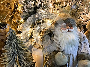 Santa Claus figure in a shop with decorative silver and golden trees