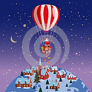 Santa Claus flying on hot air balloon on Earh little town night. Merry Christmas and Happy New Year. Gift boxes in