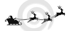 Santa Claus is flying in sleigh with Christmas reindeer. Silhouette of Santa Claus, sleigh with Christmas presents