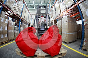 Santa Claus forklift operator in warehouse