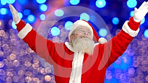 Santa Claus gesturing, lights background.