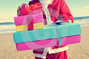 Santa claus with gifts on the beach