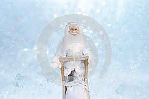 Santa Claus, or Grandfather Frost, or St. Nicholas, or Joulupukki with gifts on the against the background of sparkling snow.