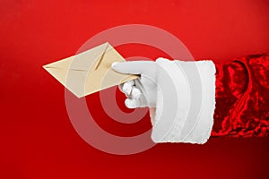 Santa Claus hand hold craft envelope with letter, sending post card. Christmas mail. Wish list