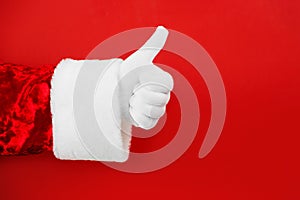 Santa Claus Hand Thumb Up Gesture on red background. Finger up. Like