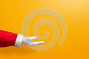 Santa Claus hand on yellow or orange isolated background
