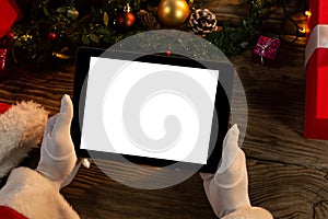 Santa Claus hands holding digital tablet