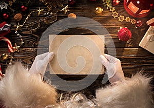 Santa Claus hands holding, reading blank letter