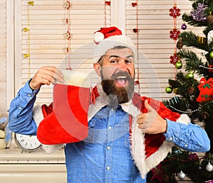 Santa Claus with happy face near Christmas tree