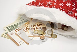 Santa Claus hat full of paper euros and dollars and coins of different countries