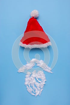 A Santa Claus hat with mustage on blue background.
