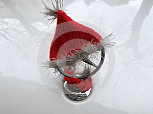 Santa Claus hat is put on a Mercedes car symbol, Christmas and New Year mood concept