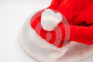 Santa Claus hat on white table with blank space to the left side